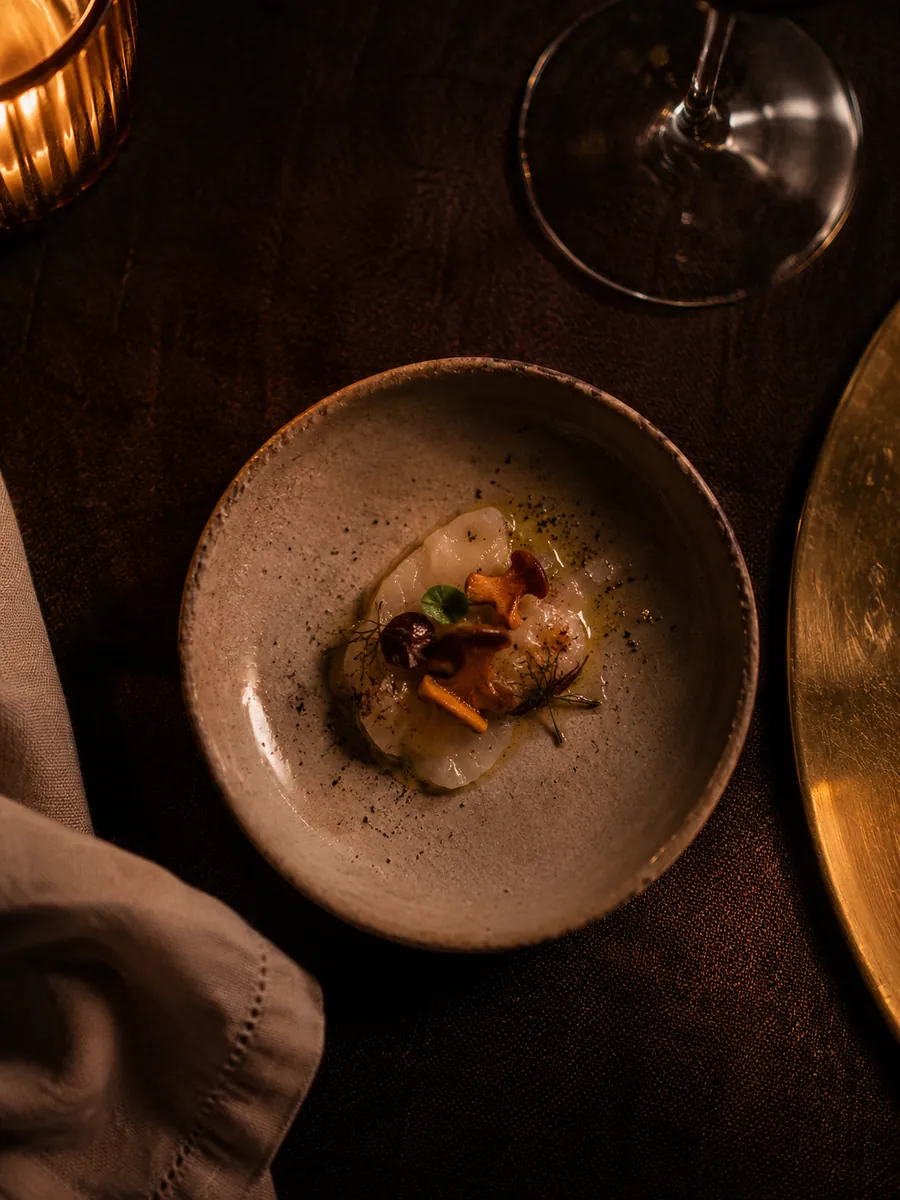 The opener plated small and considered on dark linen
